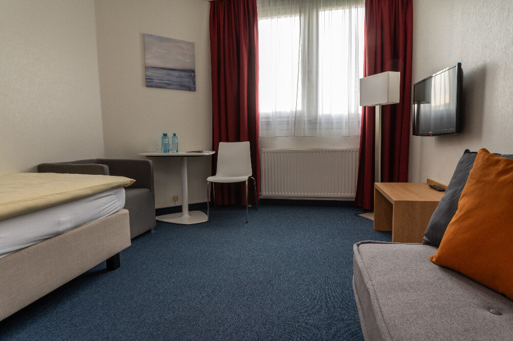 Room with sofa and red curtains